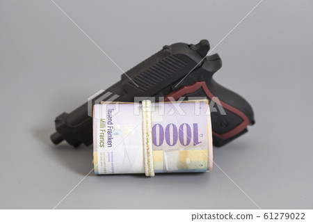 Swiss thousand francs in a roll and gun Swiss thousand francs in a roll and gun 61279022