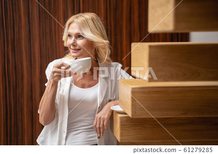 Lady holding a cup in her hand Lady holding a cup in her hand 61279285