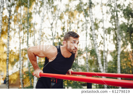 Handsome man training in a summer park Handsome man training in a summer park 61279819