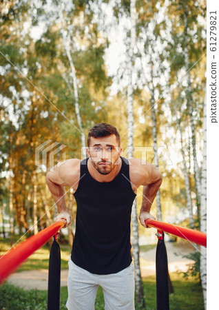 Handsome man training in a summer park Handsome man training in a summer park 61279821