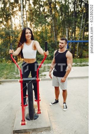 Beautiful couple training in a summer park 61280202
