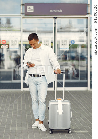 Handsome man standing near the airport Handsome man standing near the airport 61280620