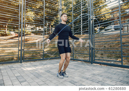 Handsome man training in a summer park 61280880