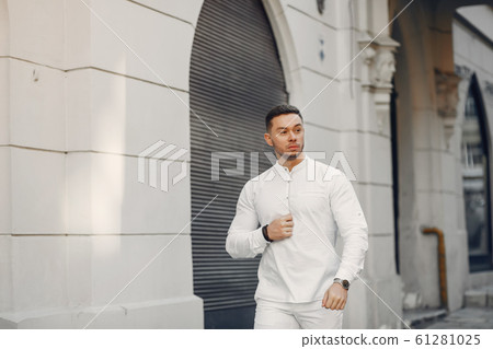 Handsome businesman in a summer city 61281025