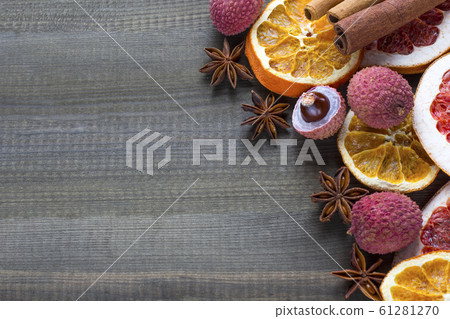 lychee fruits with dried orange and grapefruit slices on wooden background. copy space 61281270