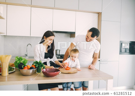 Family prepare the salad in a kitchen Family prepare the salad in a kitchen 61281512