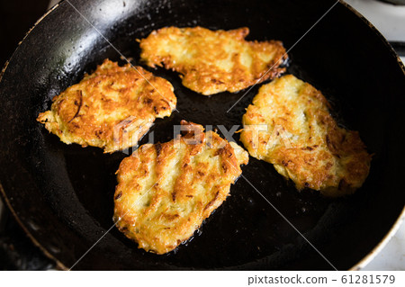 potato pancakes on pan 61281579