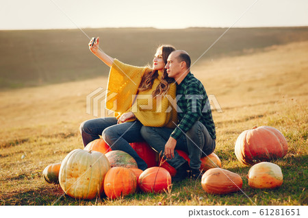 Beautiful couple spend time in a autumn park Beautiful couple spend time in a autumn park 61281651