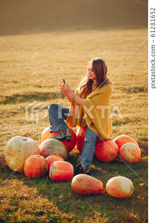 Cute and beautiful girl in a autumn park 61281652