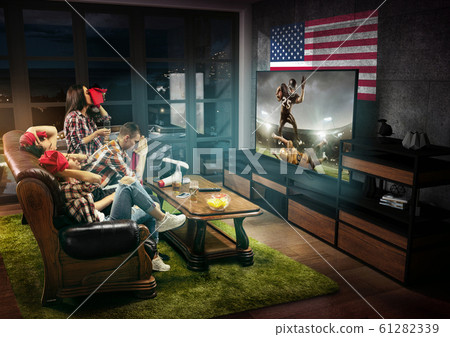 Group of friends watching TV, american football championship Group of friends watching TV, american football championship 61282339