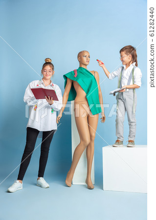 Little boy and girl dreaming about future profession of seamstress 61282440