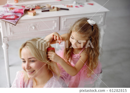 Mom and daughter at home with curlers on their heads 61282815