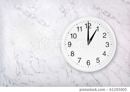 White round wall clock on marble background 61285005