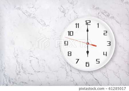 White round wall clock on white natural marble background. Six o'clock 61285017