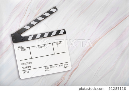 White clapboard on marble background. Open white clapper board on marble texture. Top view White clapboard on marble background. Open white clapper board on marble texture. Top view 61285118