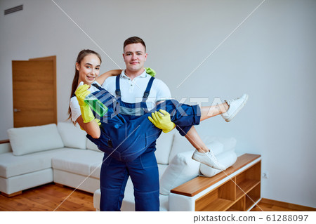 happy young cleaning company workers together after work 61288097