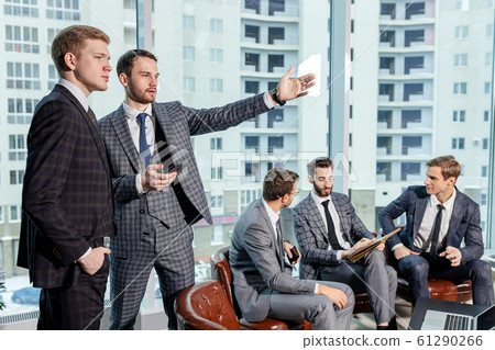 handsome guys in tux coworking 61290266