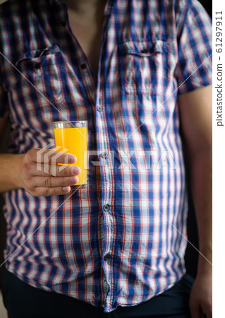 man drinking orange juice, balanced nutrition 61297911