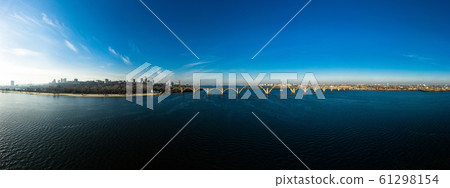 Beautiful landscape of the Ukrainian Dnipro city with old arch railway Merefo-Kherson bridge across the Dnieper river in Dnepropetrovsk, Ukraine. Beautiful landscape of the Ukrainian Dnipro city with old arch railway Merefo-Kherson bridge across the Dnieper river in Dnepropetrovsk, Ukraine. 61298154