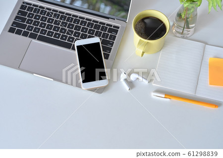 Mockup smartphone, laptop, earphone on office desk. 61298839