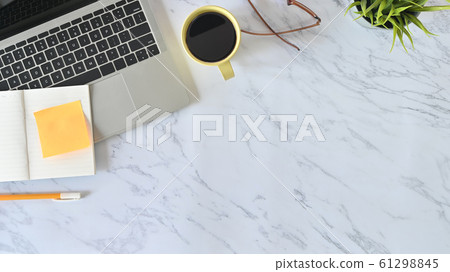 Above shot table, Office desk marble table with laptop, notebook paper, pencil, glasses. 61298845