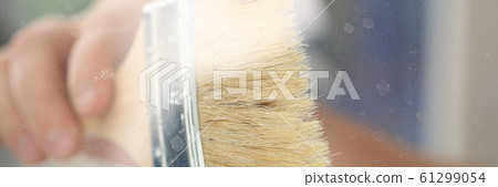 Arm of smiling worker hold brush closeup 61299054