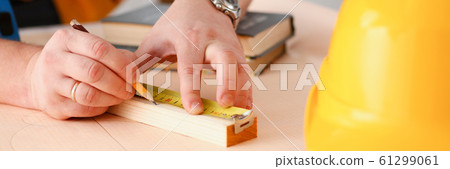 Arms of worker making structure plan on scaled paper closeup 61299061