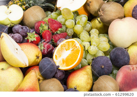 fruits background from fresh juicy fruits apples grapes, pineapple, papaya, pear, peach, figs, strawberries. 61299620