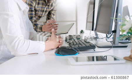 Young startup Programmers Sitting At Desks Working Young startup Programmers Sitting At Desks Working 61300867