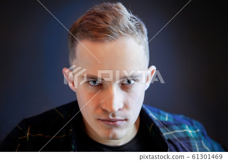 Portrait of a young man with an intense gaze. Portrait of a young man with an intense gaze. 61301469