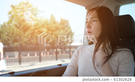 woman languishes from hot weather and travels by car woman languishes from hot weather and travels by car 61302626