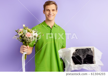 confident smiling delivery man with flowers confident smiling delivery man with flowers 61304203