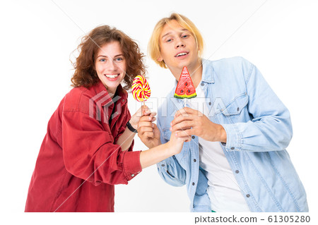 portrait of charming lovers girl and guy with candy on a white background 61305280