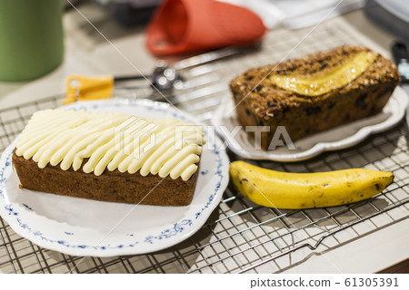 Carrot cake decorated with cream cheese and banana 61305391