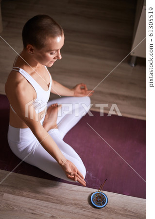 Young and beautiful woman do yoga exercises at home in livingroom Young and beautiful woman do yoga exercises at home in livingroom 61305519