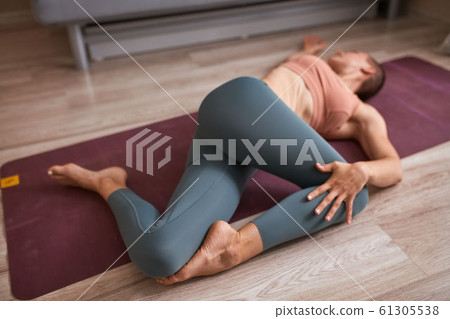 Young beautiful woman practice yoga at home on mat Young beautiful woman practice yoga at home on mat 61305538