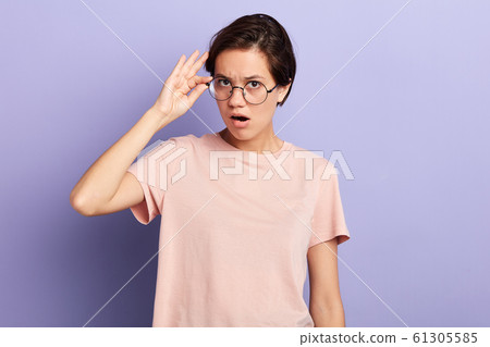 emotional woman being shocked with information 61305585