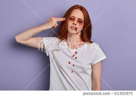injured girl with closed eyes holding her hand, palm like a pistol near her temple injured girl with closed eyes holding her hand, palm like a pistol near her temple 61305975