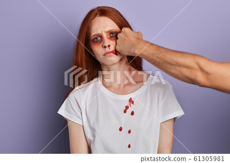 drunk cruel guy hits a girl.man beats a young woman with clenched fists 61305981