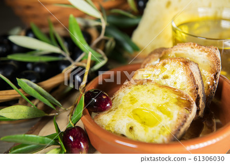 Sliced bread with extra virgin olive oil made in Salento, Puglia, Italy. Tradicional starters of mediterranean diet Sliced bread with extra virgin olive oil made in Salento, Puglia, Italy. Tradicional starters of mediterranean diet 61306030