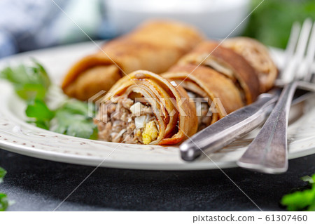 Crepes with minced beef, onions and eggs. Crepes with minced beef, onions and eggs. 61307460