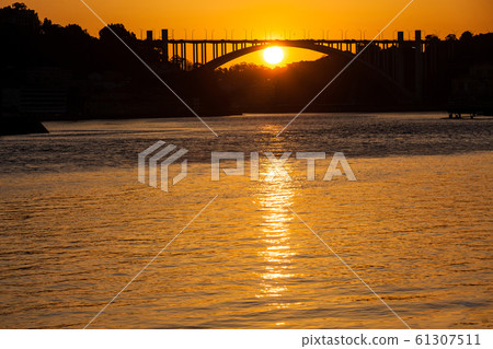 Beautiful orange sunset over the Duoro River in Porto City Beautiful orange sunset over the Duoro River in Porto City 61307511