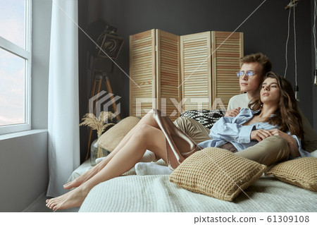 Happy young couple hugging on bed. Happy young couple hugging on bed. 61309108