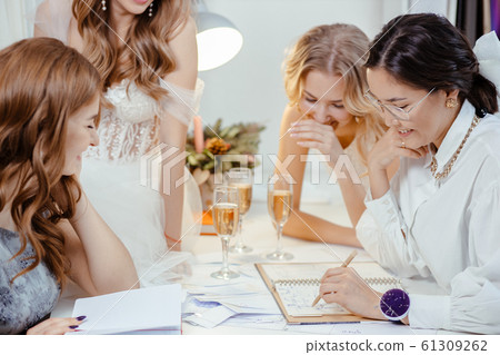 clients brides and designer in wedding salon 61309262