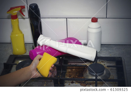 Dirty, top of the gas stove with bits of food. House cleaning. Dirty, top of the gas stove with bits of food. House cleaning. 61309325