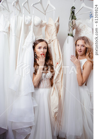two surprised women in wedding salon 61309824