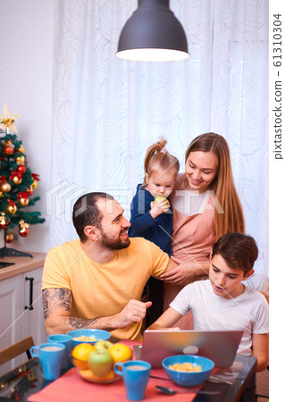 careful parents and cute kids together in kitchen careful parents and cute kids together in kitchen 61310304