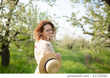 Young attractive woman with curly hair in a 61310562