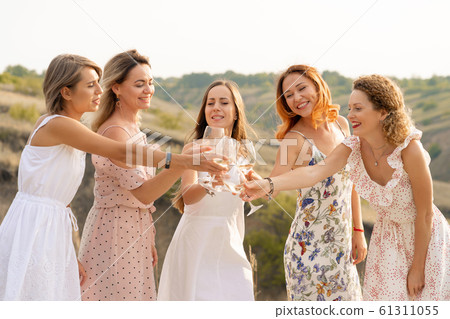 The company of female friends enjoys a summer The company of female friends enjoys a summer 61311055