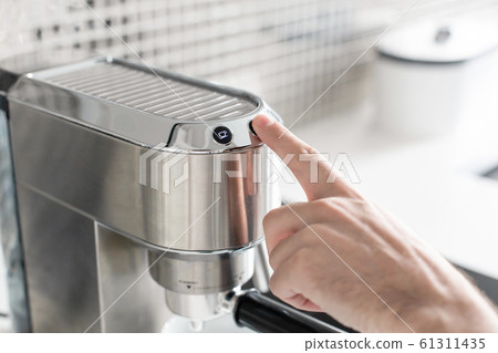 Guy prepare delicious aromatic coffee in a coffee Guy prepare delicious aromatic coffee in a coffee 61311435